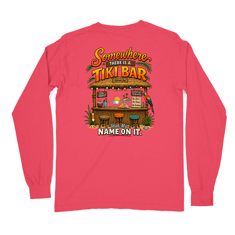 A bright pink long-sleeve t-shirt with a colorful graphic on the front. The graphic features a tropical beach bar scene with the text 'Somewhere THERE IS A TIKI BAR' and 'With My NAME ON IT.