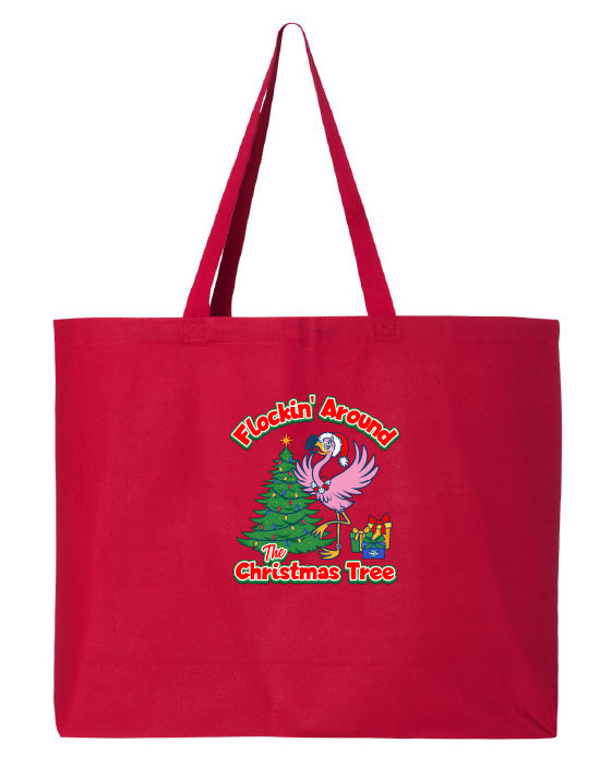 Red tote bag with Christmas-themed design featuring a flamingo and tree on a white background