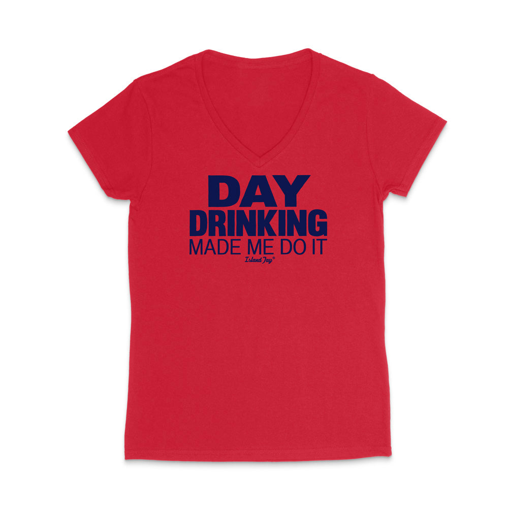 A red women's short-sleeve V-neck t-shirt with a dark navy blue graphic text print reading 'DAY DRINKING MADE ME DO IT' on the chest, displayed against a solid white background.