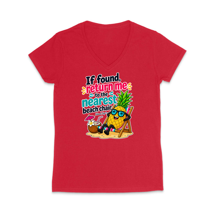 A red short-sleeve V-neck t-shirt with a colorful graphic of a pineapple wearing sunglasses and lounging on a beach chair next to a coconut drink, with the text 'If found, return me to the nearest beach chair'.
