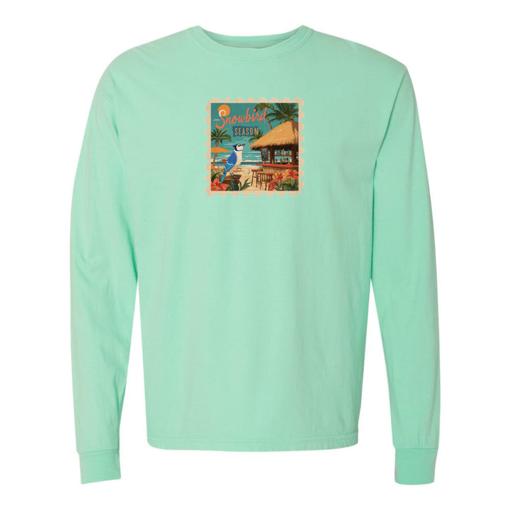Mint green long-sleeve shirt with a colorful graphic on a white background