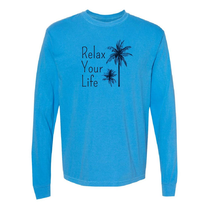 Blue long-sleeve shirt with 'Relax Your Life' text and palm tree design on a white background