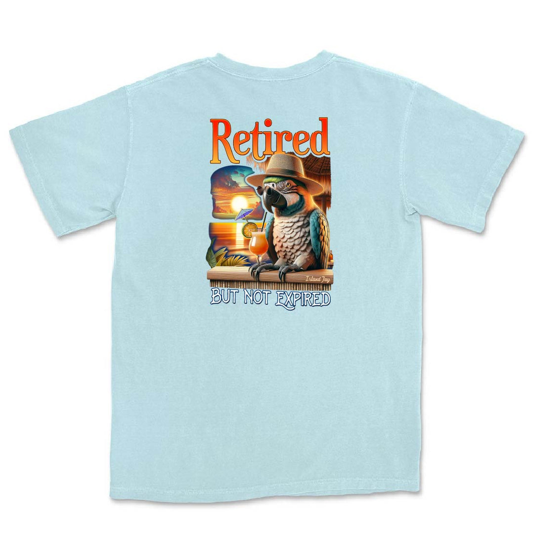 Light blue t-shirt with a graphic of a parrot in a cowboy hat and sunglasses, and the text 'Retired but not expired' on a white background.