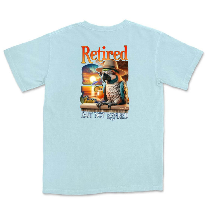 Light blue t-shirt with a graphic of a parrot in a cowboy hat and sunglasses, and the text 'Retired but not expired' on a white background.