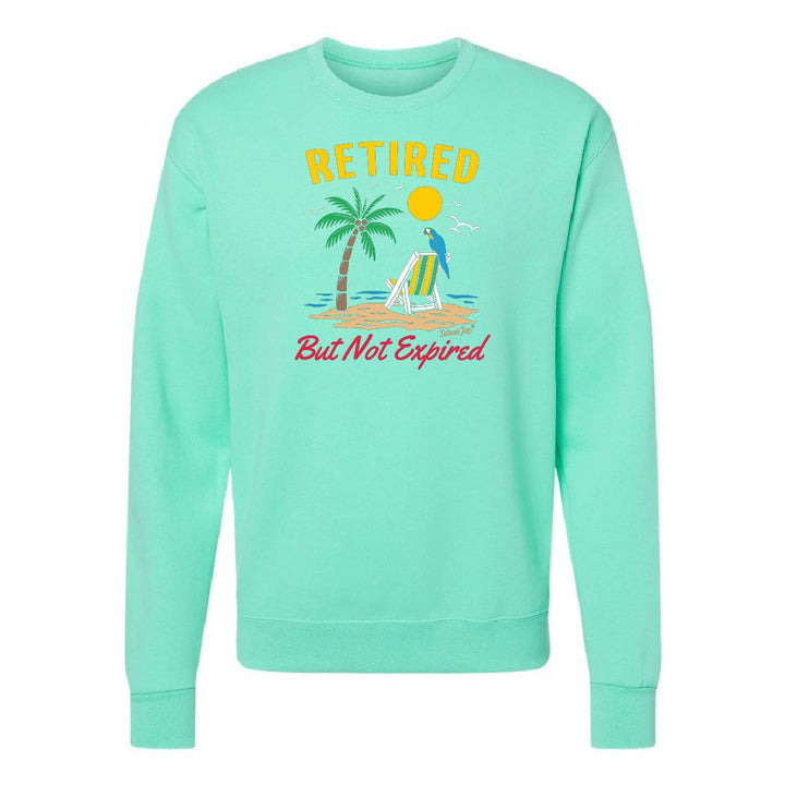 Mint green sweatshirt with beach graphic and text 'Retired But Not Expired' on a white background