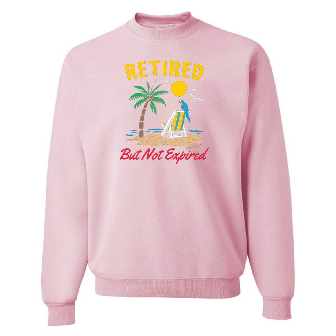 Pink sweatshirt with beach graphic and text 'Retired But Not Expired' on a white background