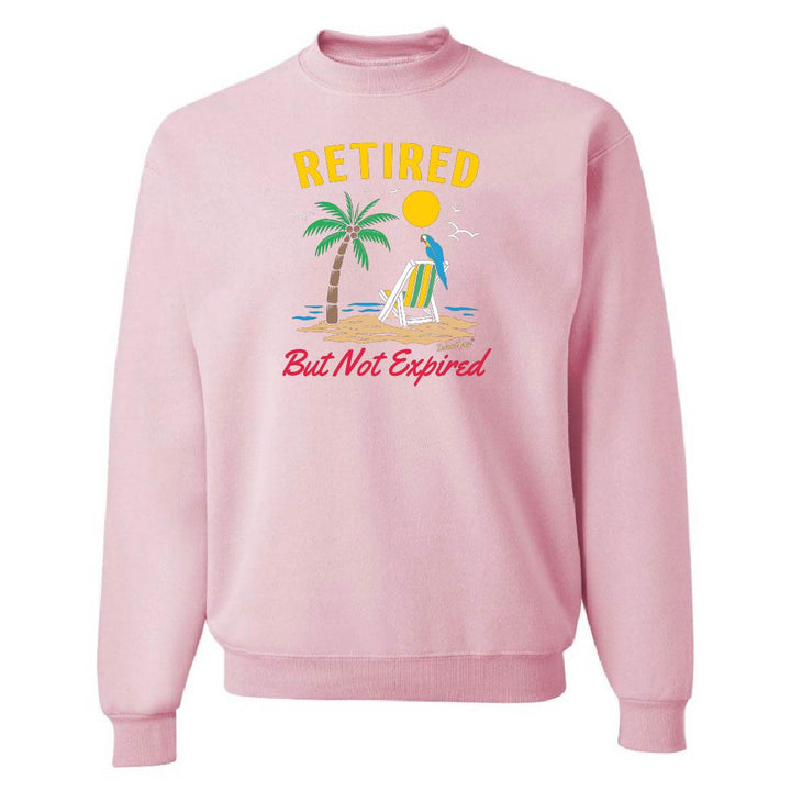 Pink sweatshirt with beach graphic and text 'Retired But Not Expired' on a white background