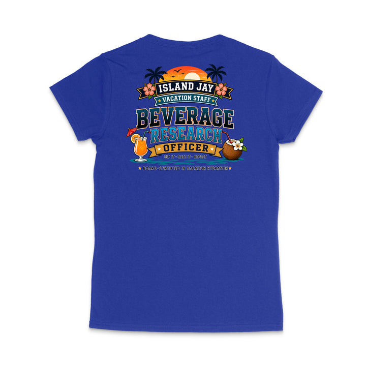 A royal blue short-sleeve t-shirt shown from the back, featuring a colorful graphic print with tropical island-themed text reading 'ISLAND JAY VACATION STAFF BEVERAGE RESEARCH OFFICER' and cartoon illustrations of a cocktail, coconut, and flowers.