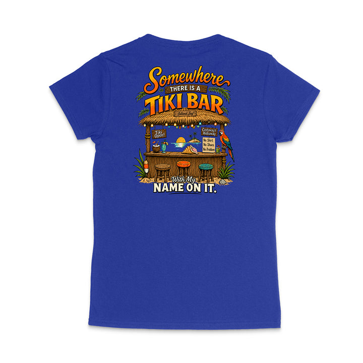 A royal blue short-sleeve t-shirt shown from the back, featuring a large, colorful graphic print of a tiki bar with the text 'Somewhere THERE IS A TIKI BAR' and 'With My NAME ON IT.'.