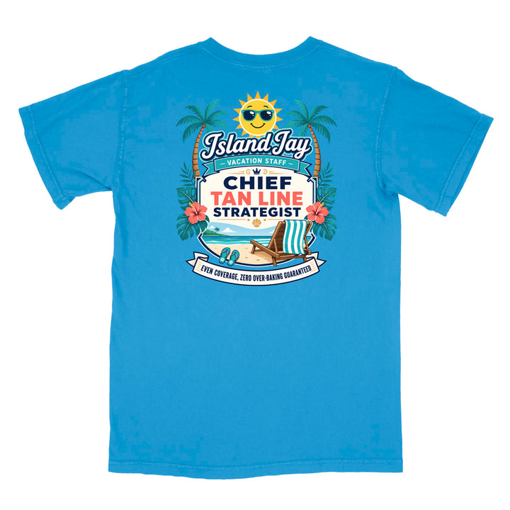 A blue short-sleeve t-shirt with a colorful graphic print on the front. The graphic features a smiling sun wearing sunglasses, palm trees, a beach scene, and text that reads 'Island Jay Vacation Staff by CHIEF TAN LINE STRATEGIST'.