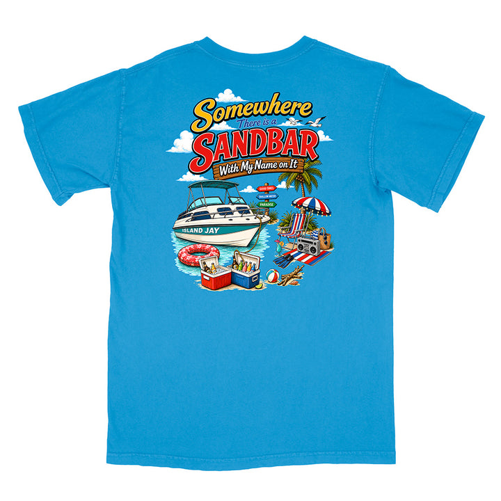 A bright blue short-sleeve t-shirt shown flat against a white background, featuring a colorful graphic print on the front with the text 'Somewhere in the Sandbar With My Name on It' and beach-themed illustrations.