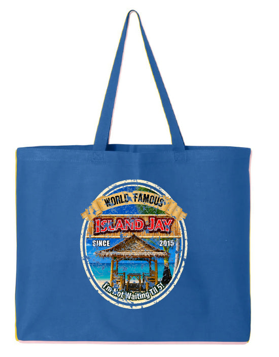 A blue canvas tote bag with two shoulder straps, featuring a circular graphic print on the front that reads 'World Famous Island Jay' with an illustration of a beach pavilion and the phrase 'I'm not Waiting Til 5'.