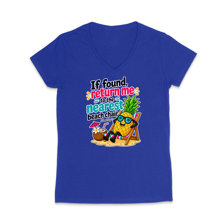 A royal blue women's V-neck t-shirt with a colorful graphic on the front featuring a pineapple character wearing sunglasses and sitting in a beach chair next to a coconut shell umbrella, with the text 'If found, return me to the nearest beach chair' in stylized lettering.