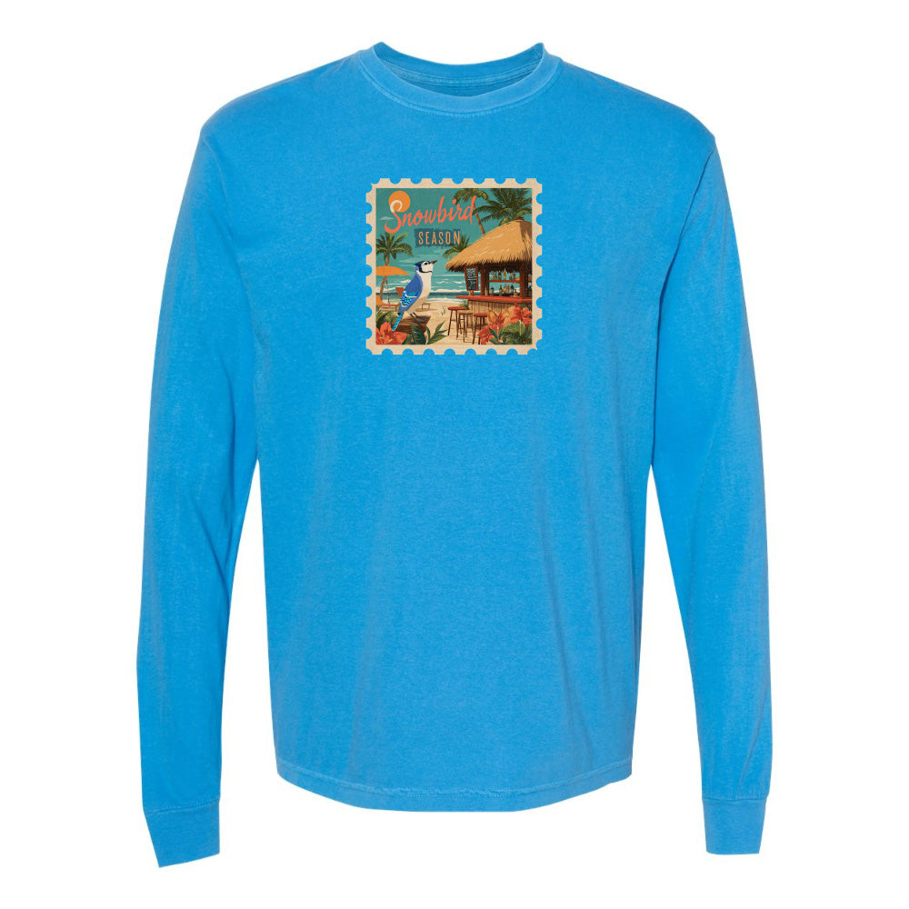 Blue long-sleeve shirt with a tropical design on a white background