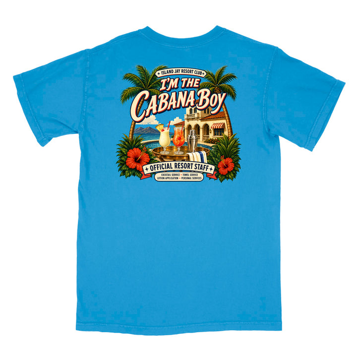 A bright blue short-sleeve t-shirt shown flat against a white background, featuring a large colorful graphic print on the back with palm trees, hibiscus flowers, a cabana, and the text 'I'm The Cabana Boy' and 'Official Resort Staff'.
