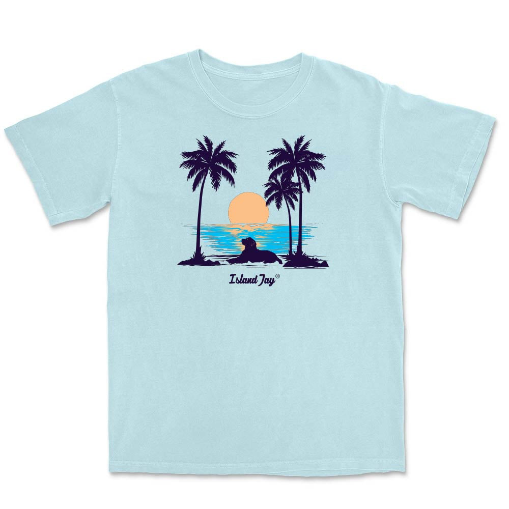 Light blue t-shirt with palm tree and sunset design on a white background