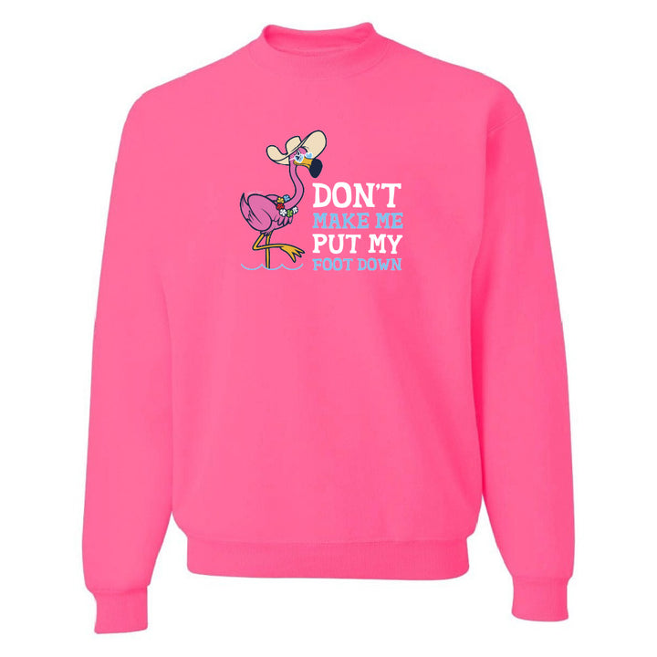 Pink sweatshirt with a flamingo graphic and text on a white background