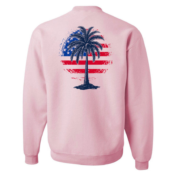 Pink sweatshirt with a palm tree design on the back featuring an American flag pattern.