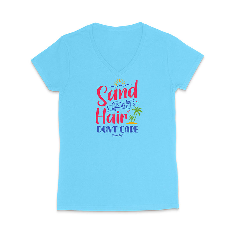 Light blue t-shirt with colorful text reading "Sand In My Hair Don't Care" on a white background