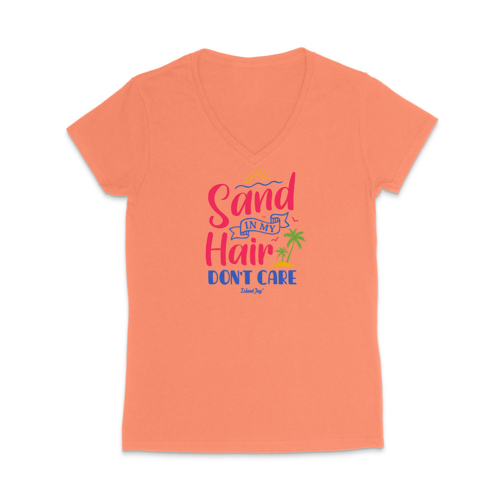 Coral t-shirt with colorful text reading "Sand In My Hair Don't Care" on a white background