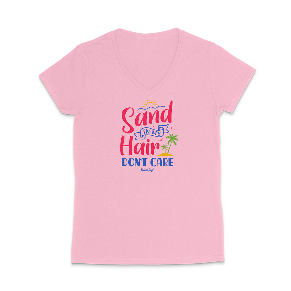 Pink t-shirt with colorful text reading "Sand In My Hair Don't Care" on a white background