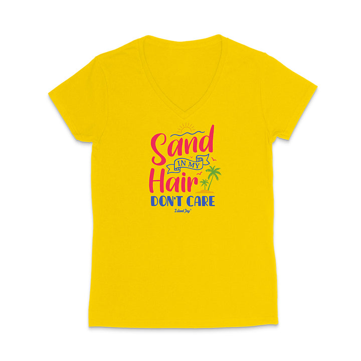 Yellow t-shirt with colorful text reading "Sand In My Hair Don't Care" on a white background