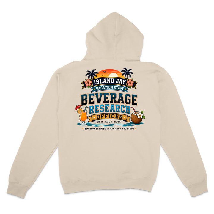 A beige hooded sweatshirt shown from the back, featuring a colorful graphic print with palm trees, a sunset, and tropical drink illustrations above the text 'ISLAND JAY BEVERAGE RESEARCH OFFICER'.