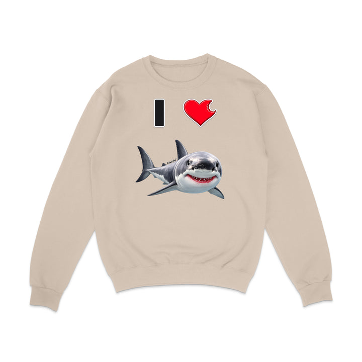 A beige crewneck sweatshirt featuring a graphic print of a great white shark and the text 'I' followed by a red heart, displayed on a clean white background.