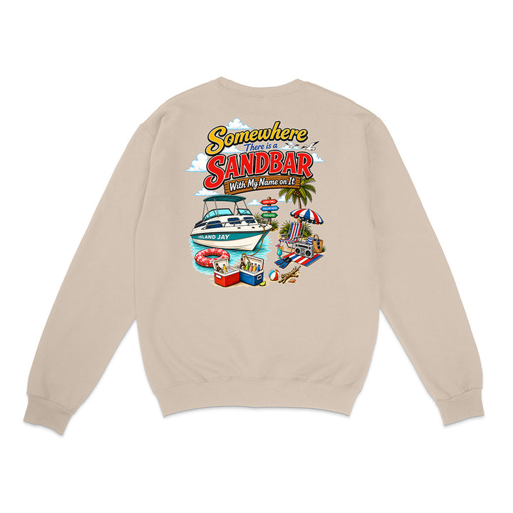 A beige crewneck sweatshirt shown from the back, featuring a colorful graphic print with the text 'Somewhere There is a SANDBAR' and illustrations of a boat, beach chair, palm tree, and pool.