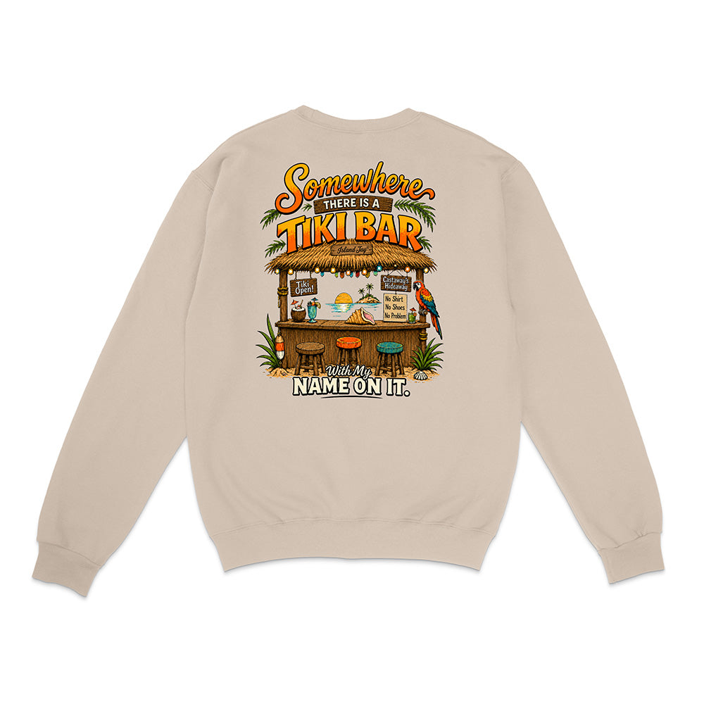 A beige crewneck sweatshirt shown from the back, featuring a colorful graphic of a tropical tiki bar with the text 'Somewhere There Is A TIKI BAR and My NAME ON IT.'.