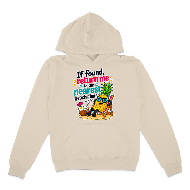 A beige pullover hoodie with a colorful graphic print on the chest. The graphic features a cartoon pineapple wearing sunglasses and relaxing in a beach chair next to a cocktail, with the text 'If found, return me to the nearest beach chair'.