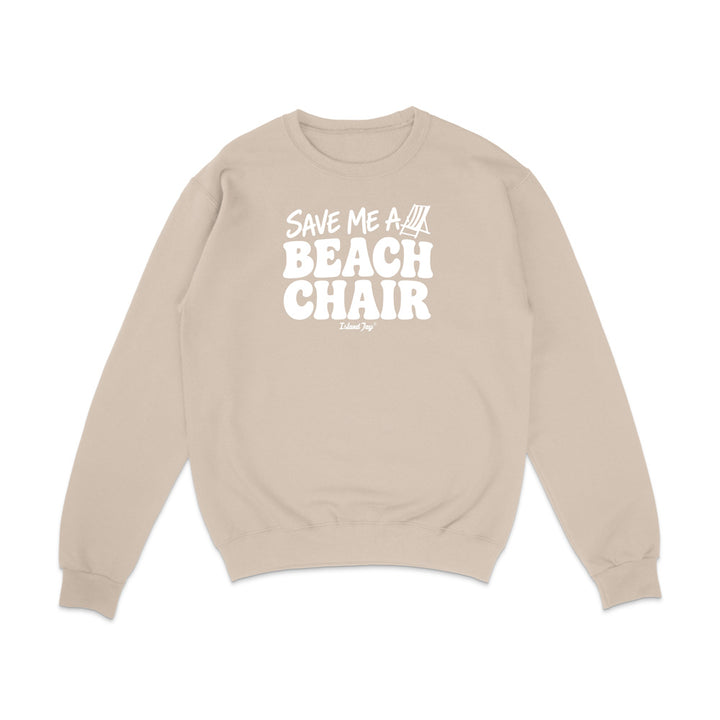 A beige crewneck sweatshirt with a white graphic print on the front that reads 'SAVE ME A BEACH CHAIR'