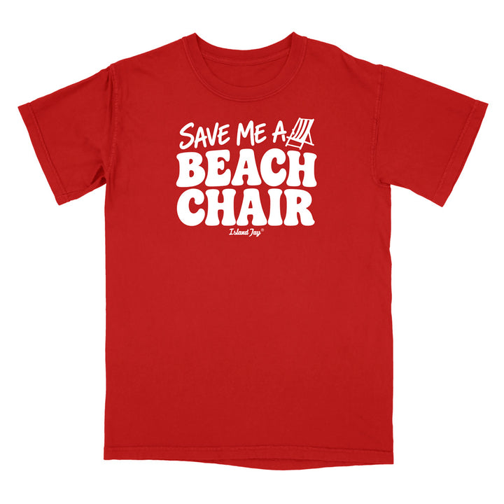 A red short-sleeve crewneck t-shirt with a bold white graphic print on the front reading 'SAVE ME A BEACH CHAIR' .