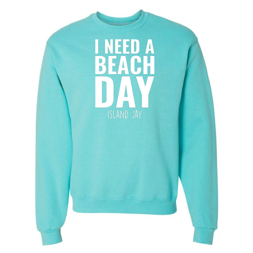 Turquoise sweatshirt with 'I NEED A BEACH DAY' text on a white background