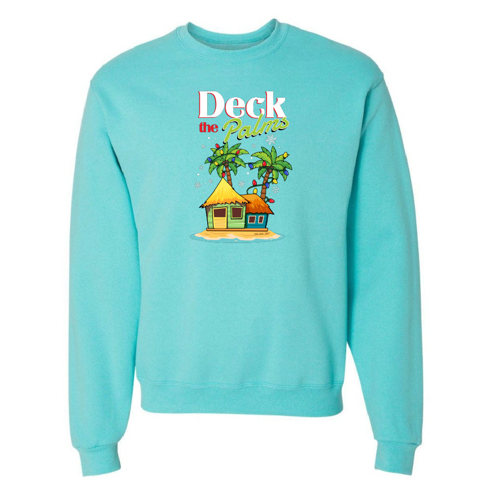 Blue sweatshirt with a tropical hut and palm tree design and graphic text reading "Deck The Palms" on a white background