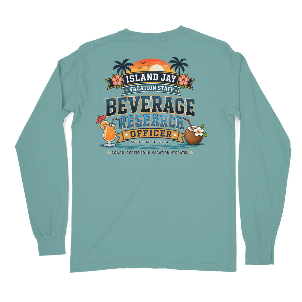 A light blue long-sleeve t-shirt shown from the back, featuring a colorful graphic print with tropical beach elements and the text 'ISLAND JAY VACATION STAFF BEVERAGE RESEARCH OFFICER'.