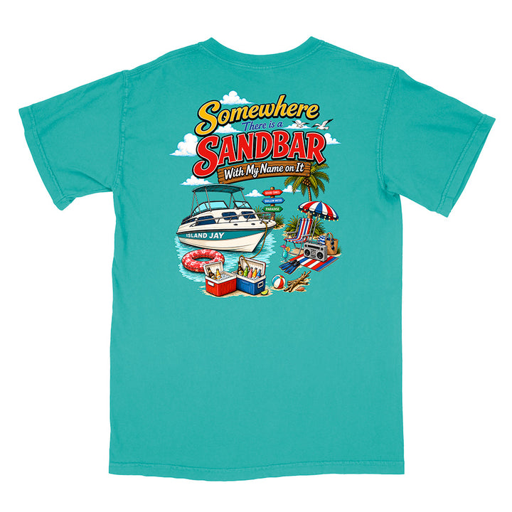 A turquoise short-sleeve t-shirt with a colorful graphic print on the front. The graphic features the text 'Somewhere I Found the SANDBAR With My Name on It' in a retro yellow and red font, above an illustration of a white speedboat, a beach umbrella, a cooler, and a beach chair.