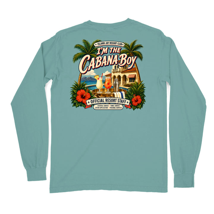 A long-sleeve t-shirt in a dusty teal color, shown from the back. The back features a large, colorful graphic print with palm trees, hibiscus flowers, a cocktail, and a resort building, with text reading 'I'M THE CABANA BOY' and 'OFFICIAL RESORT STAFF'.