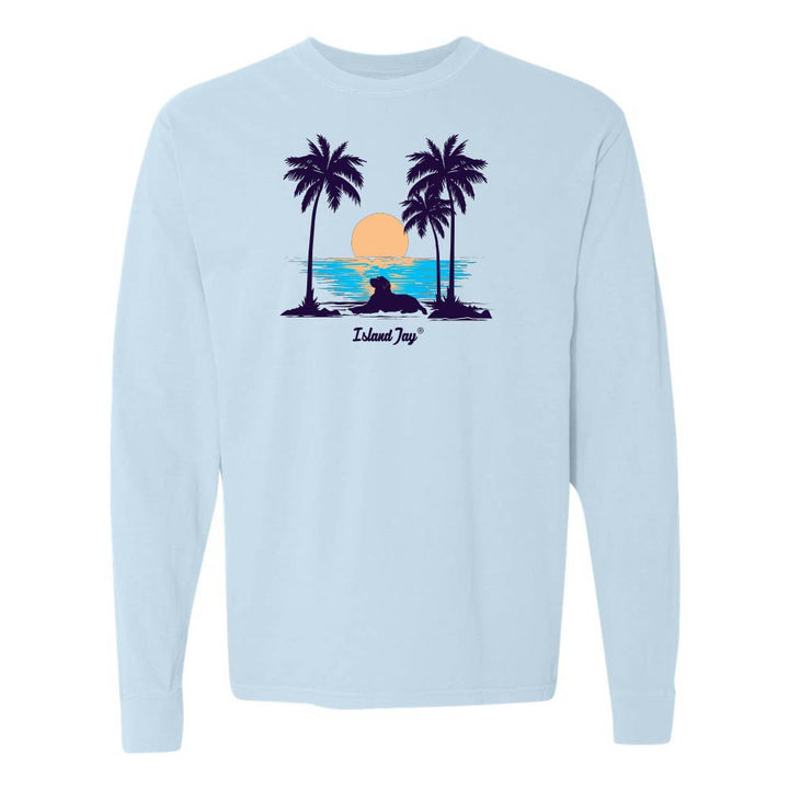 Light Blue Long Sleeve T-Shirt with sunset, dog and palm trees graphic.