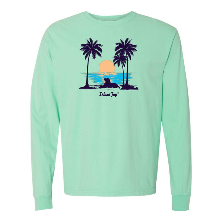 Light Green Long Sleeve T-Shirt with sunset, dog and palm trees graphic.