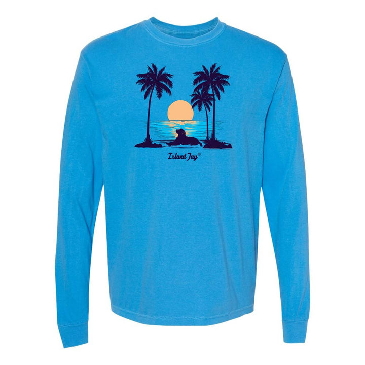 Blue Long Sleeve T-Shirt with sunset, dog and palm trees graphic.