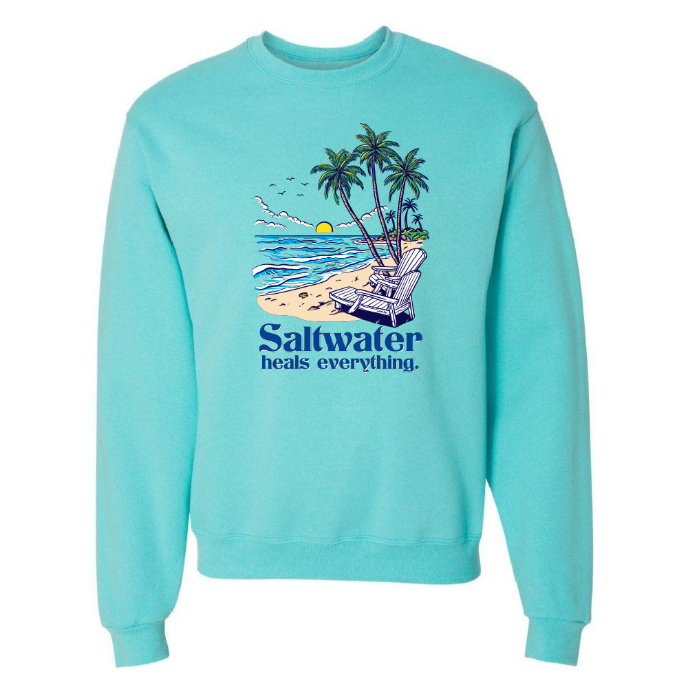 Turquoise sweatshirt with beach graphic and 'Saltwater heals everything' text on a white background