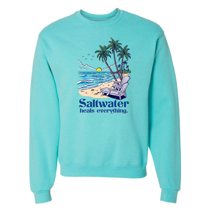 Turquoise sweatshirt with beach graphic and 'Saltwater heals everything' text on a white background
