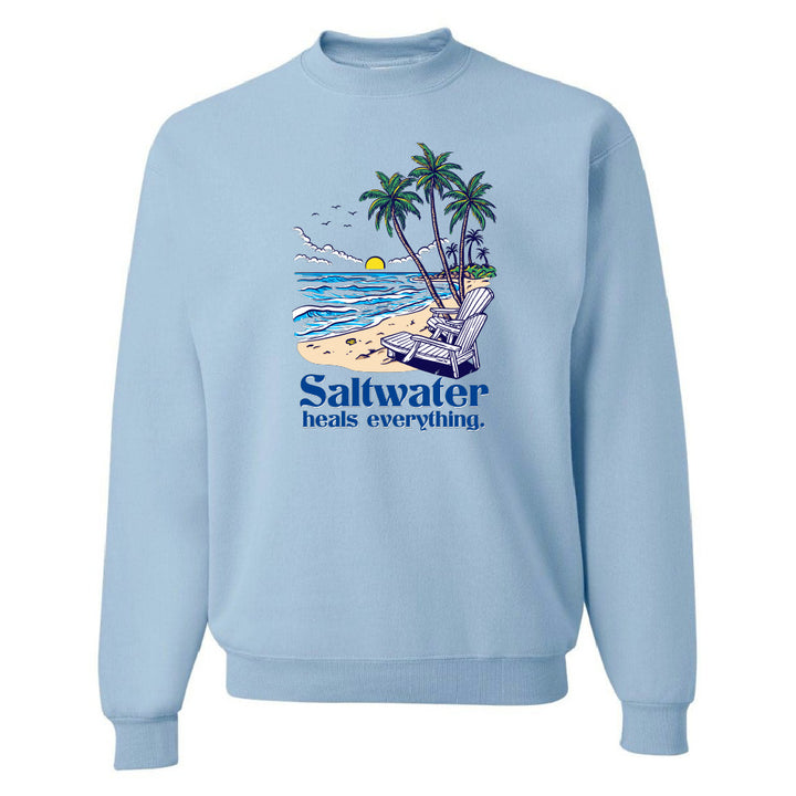 Light blue sweatshirt with a beach graphic and 'Saltwater heals everything' text on a white background