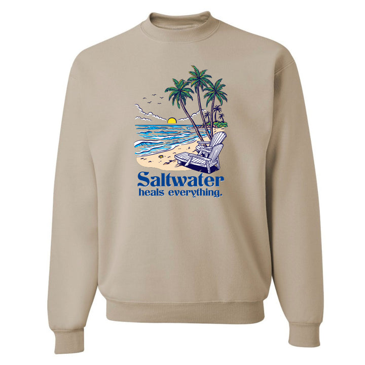 Beige sweatshirt with a beach graphic and 'Saltwater heals everything' text on a white background