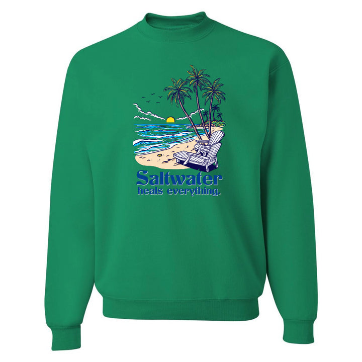 Green sweatshirt with beach graphic and 'Saltwater heals everything' text on a white background