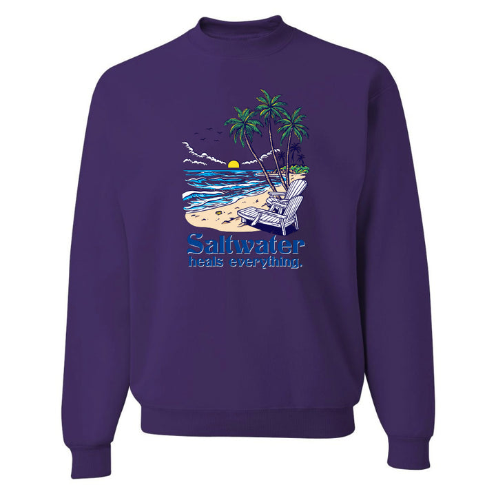 Purple sweatshirt with a beach graphic and text on a white background