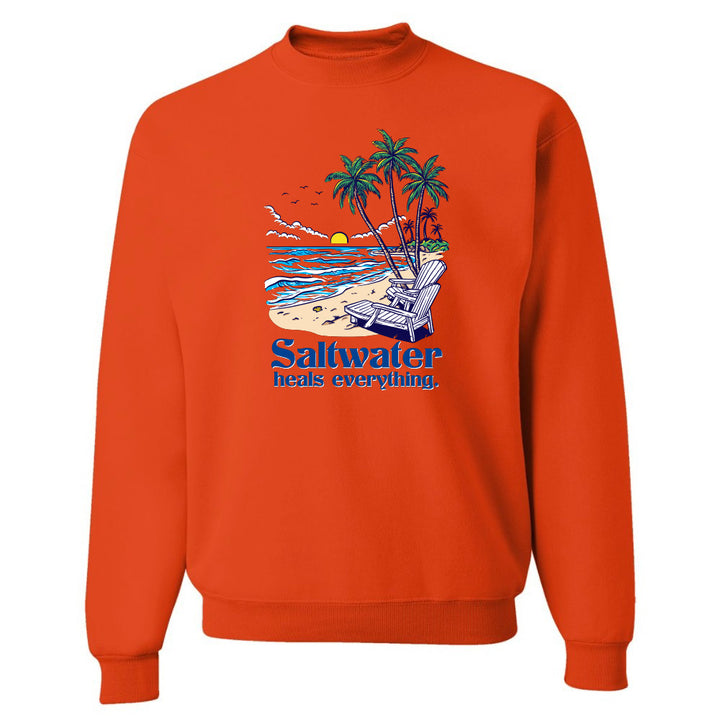 Orange sweatshirt with a beach graphic and 'Saltwater heals everything' text on a white background