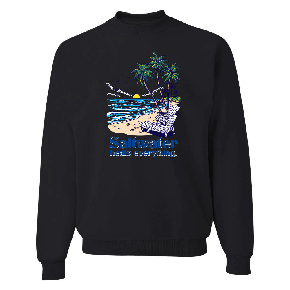 Black sweatshirt with a beach graphic and 'Saltwater heals everything' text on a white background