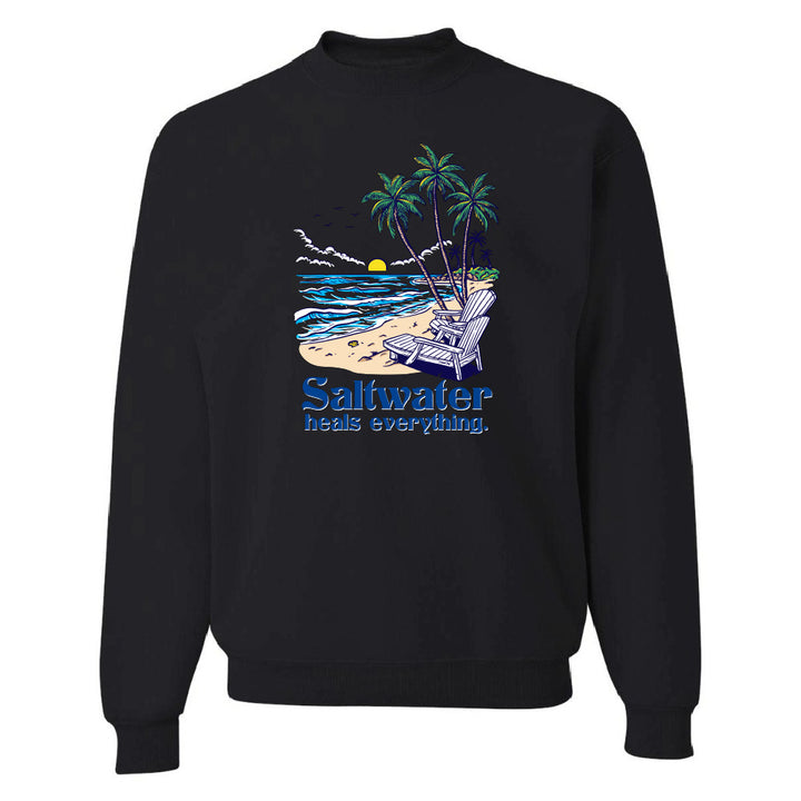 Black sweatshirt with a beach graphic and 'Saltwater heals everything' text on a white background